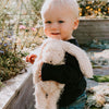 Child holding Harey the Bunny Rabbit plush toy