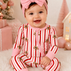 Smiling baby in Zip Romper Gingerbread Lane Pink pajamas lifestyle photo