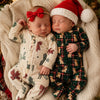 Two babies in matching Christmas pajamas lifestyle photo