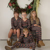 Siblings in matching Holiday Stripe pajamas