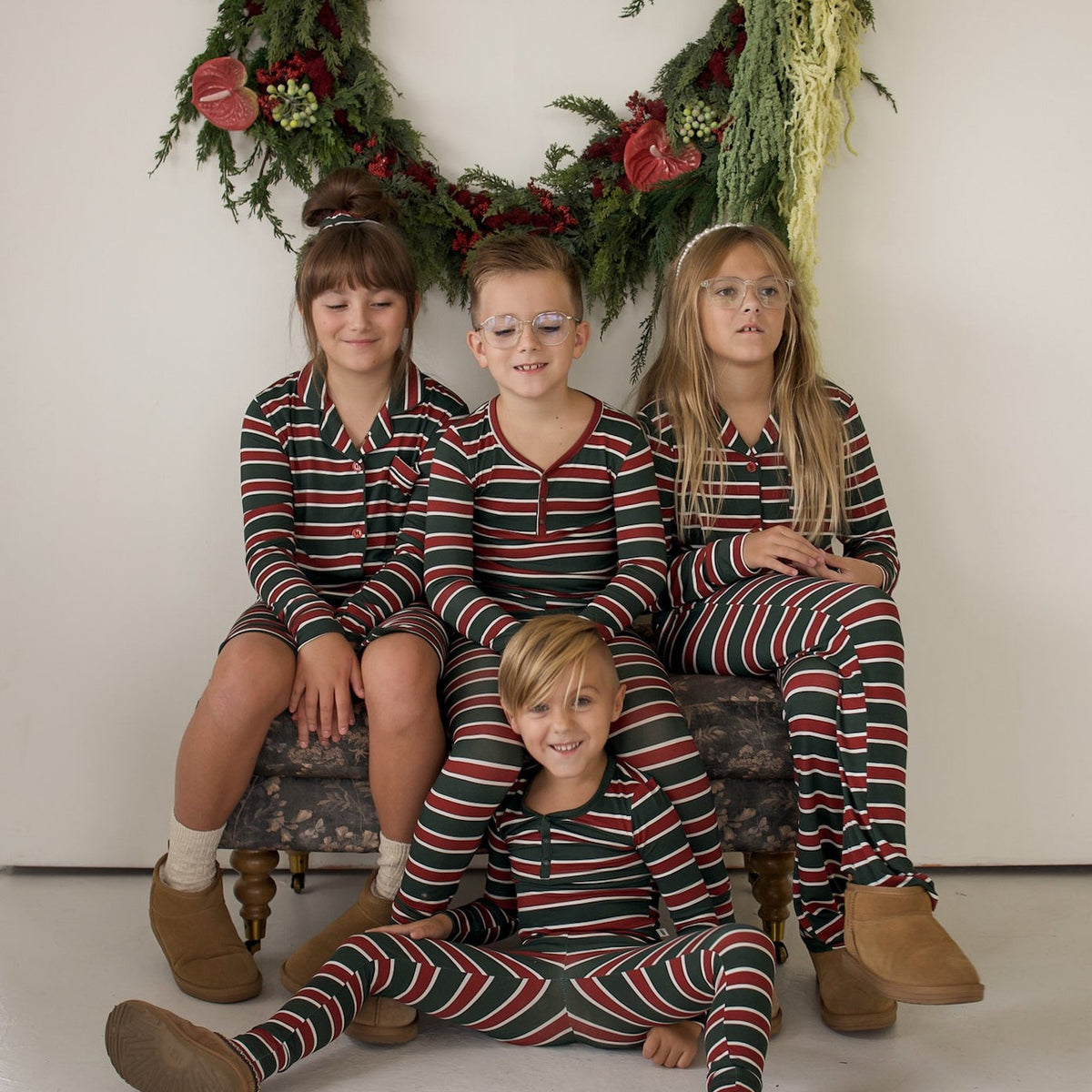 Siblings in matching Holiday Stripe pajamas