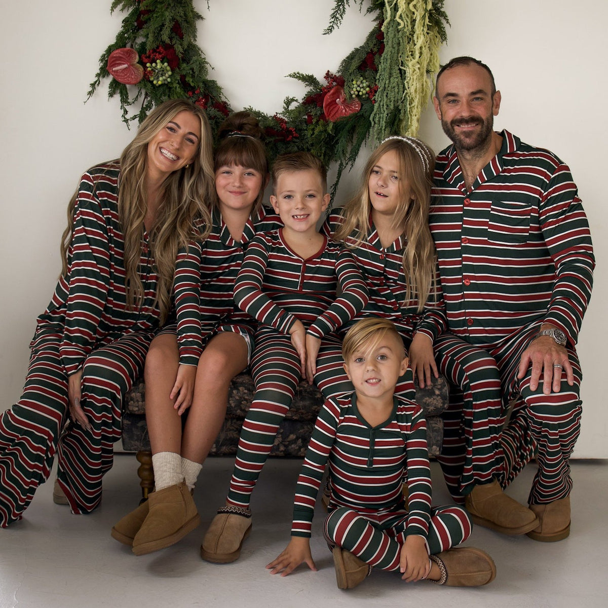 Whole family in matching Holiday Stripe Christmas pajamas