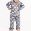 Child wearing a blue pajama set with floral and bow pattern on a white background