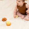 Baby playing with silicone stacking flowers
