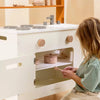 Child playing with wooden kitchen