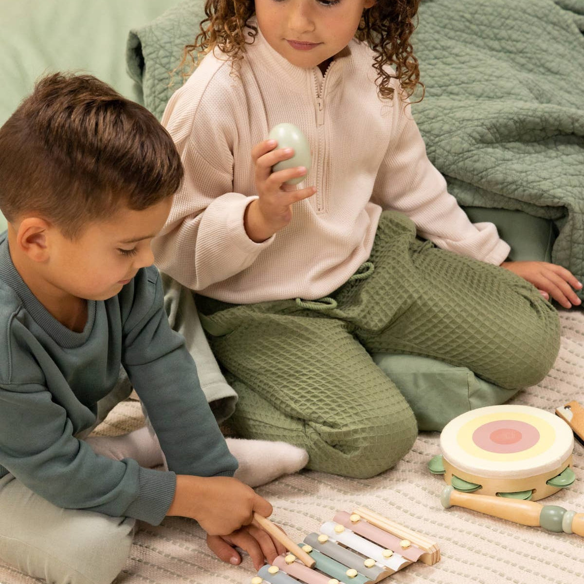 Kids playing with wooden musical instruments