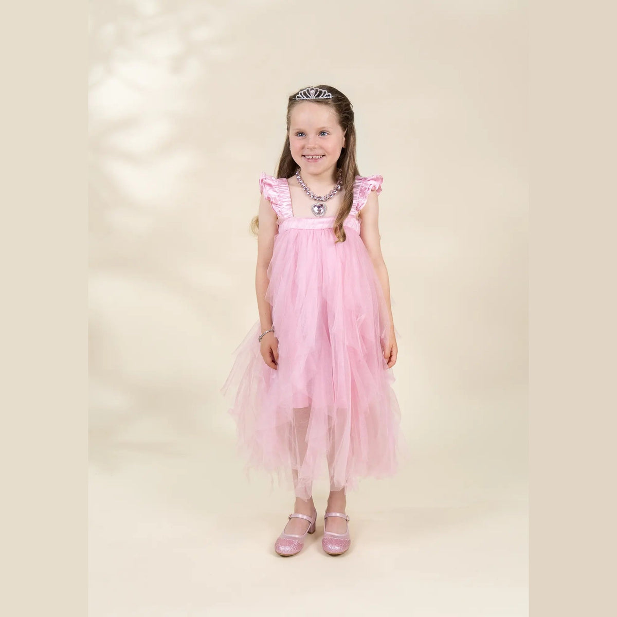 Child wearing pink ruffle princess dress