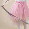 Child twirling ribbon wand in tutu