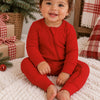 Baby in Red Ribbed Zip Romper on Christmas morning