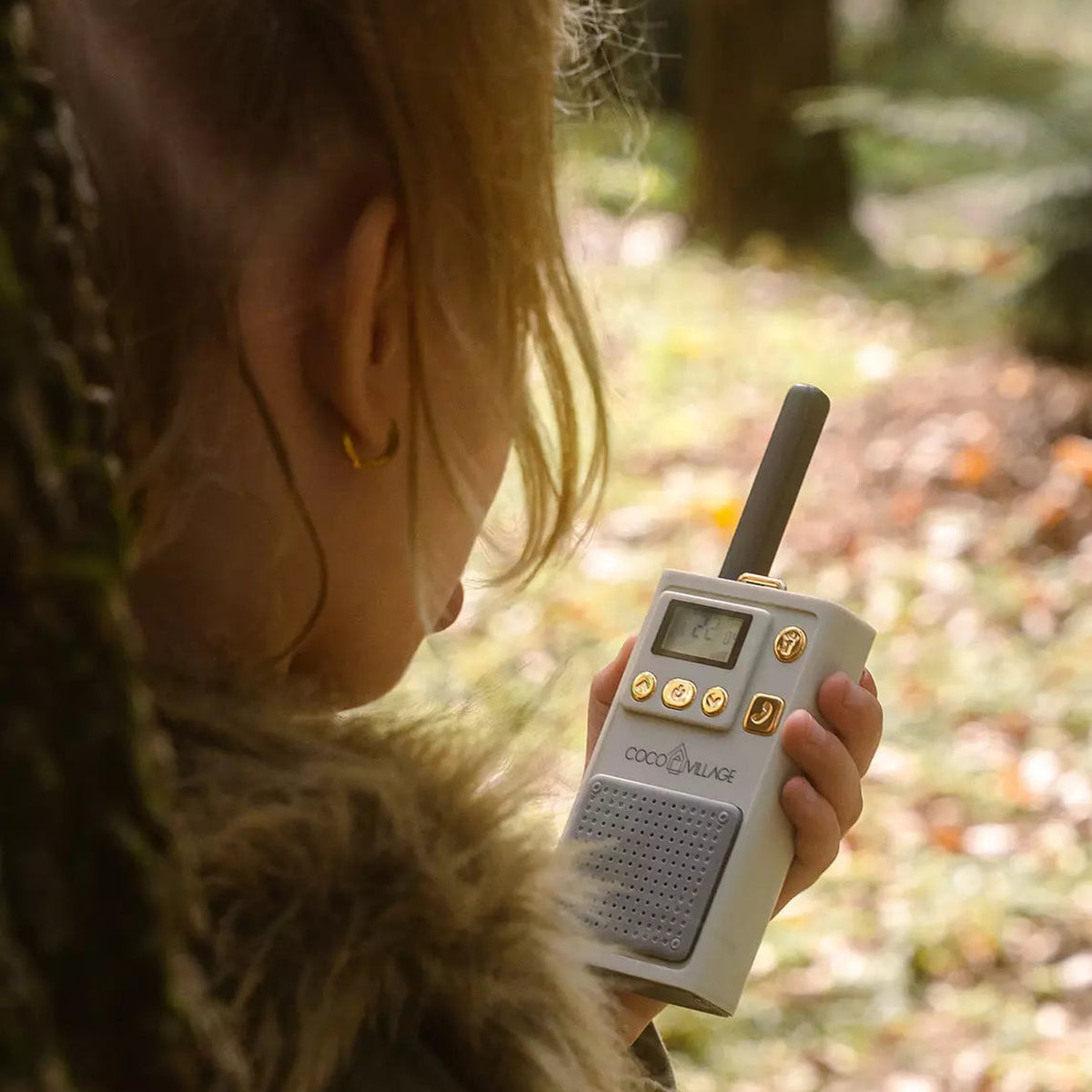 Child using walkie talkie outdoors